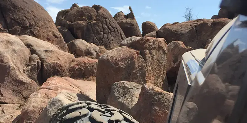 Multiple off-road vehicles navigating a rocky canyon at Katemcy Rocks.